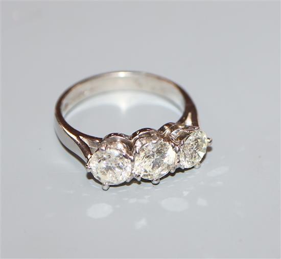 A modern platinum and three stone diamond ring, size L.